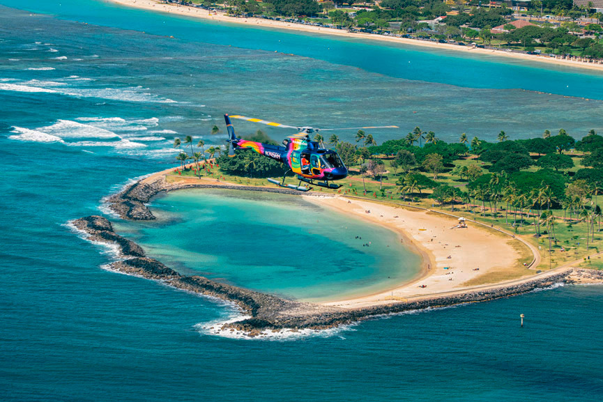 A Rainbow Helicopter flying past MAgic Island Lagoon