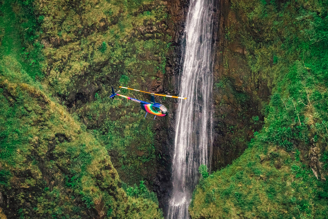 A Rainbow Helicopter Tour, Oahu flying above a waterfall