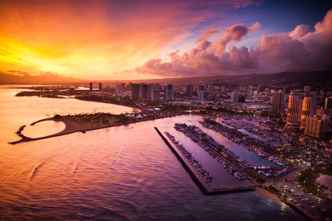 Oahu by helicopter aerial photography of Waikiki sunset.