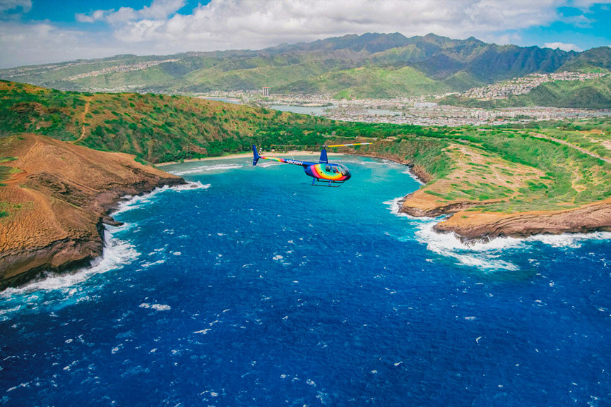 Rainbow Helicopter flying over the ocean with a beautiful landscape of Hanauma Bay