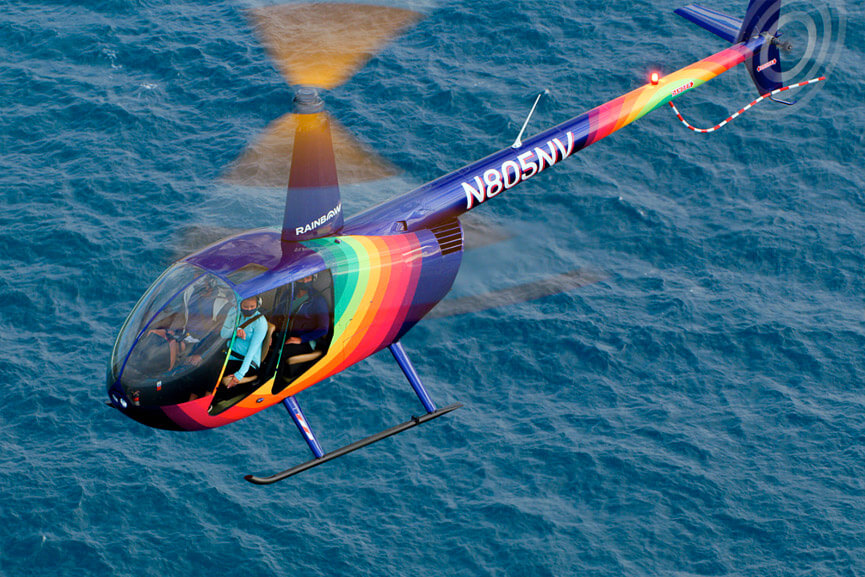 Rainbow Helicopter flying over Waikiki waters
