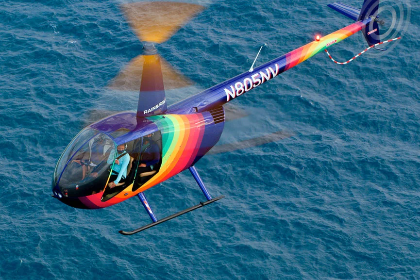 Rainbow Helicopter flying over Waikiki waters