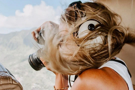 Rainbow Oahu Helicopter Tour - A person taking a photograph