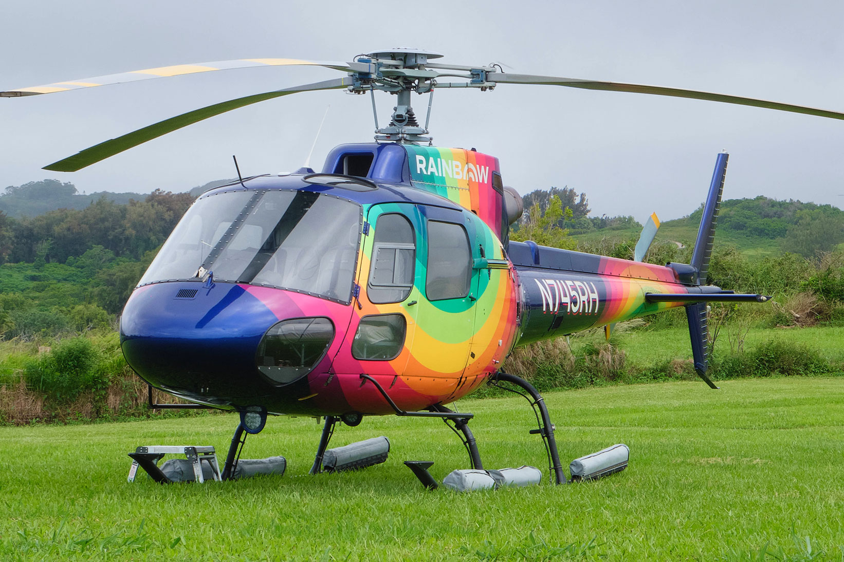 Rainbow Helicopters Airbus Astar landing on green grass in Hawaii