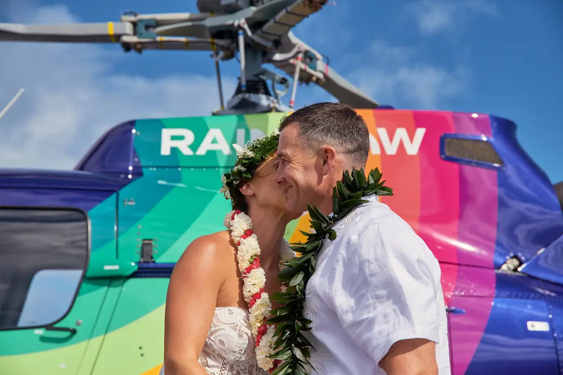 Private helicopter Oahu, helicopter proposal flight. A couple sharing a fun, moment on a Rainbow Helicopter tour of Oahu, Hawaii.