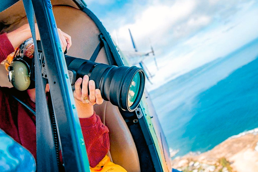 Rainbow Oahu Helicopter Tour - A person taking a photograph