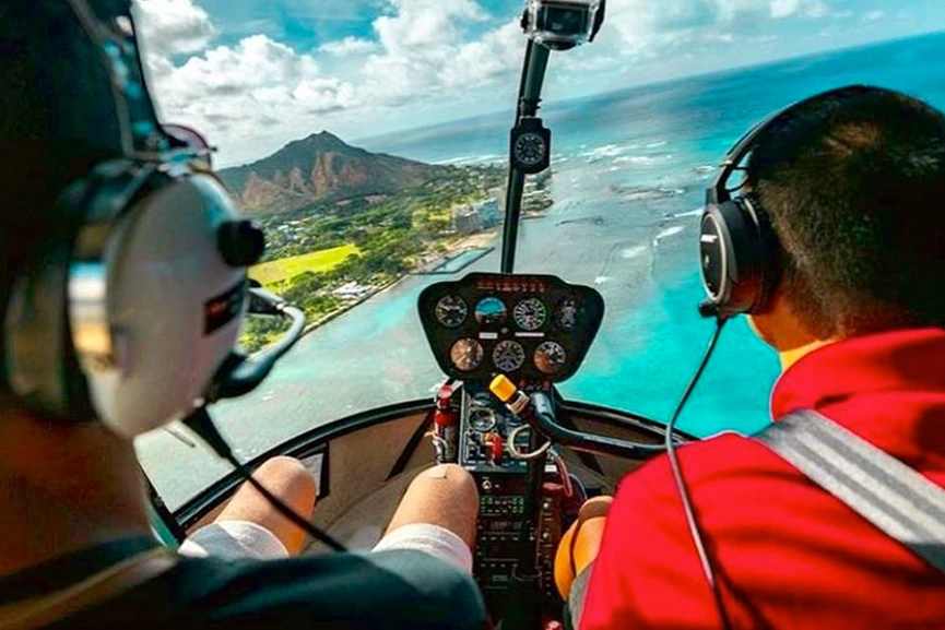 Helicopter pilot and passenger approaching Diamond Head by air