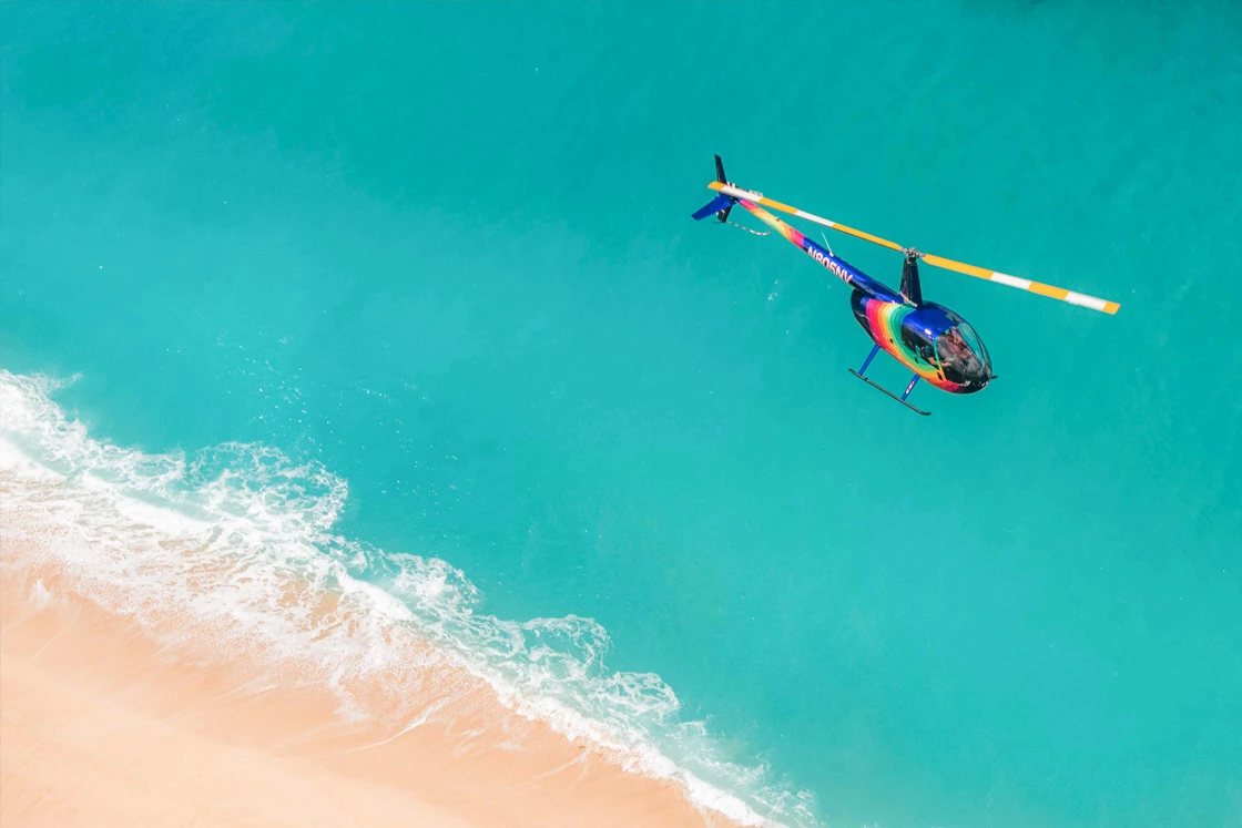 Rainbow Helicopter flying over the beach in Waikiki