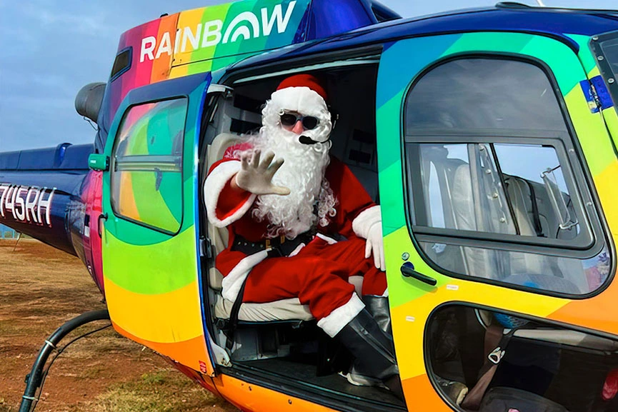 Santa Claus waving from Rainbow Helicopter