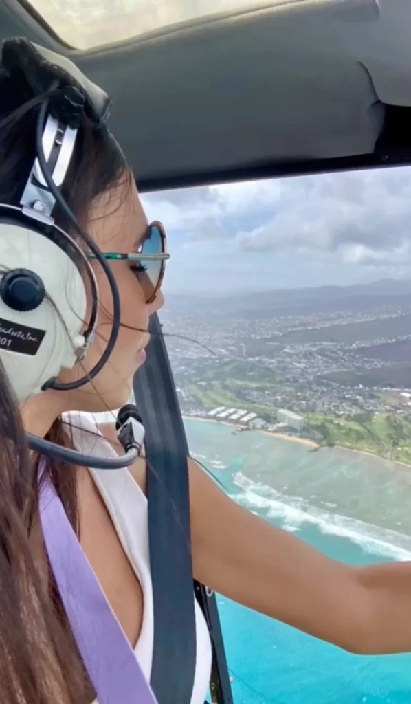 Video thumbnail of woman in helicopter flying above Oahu coastlines