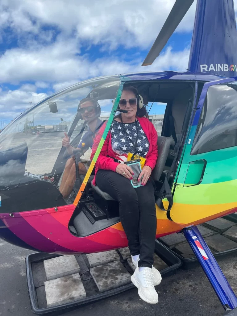 Woman with cell phone and American flag shirt inside Rainbow Helicopter on Oahu
