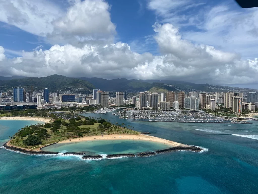 Honolulu skyline and Magic Island aerial view as seen from Oahu helicopter tour