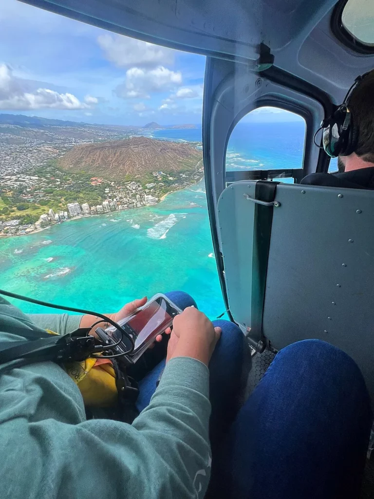 Passenger view from helicopter above Diamond Head on doors-off helicopter tour
