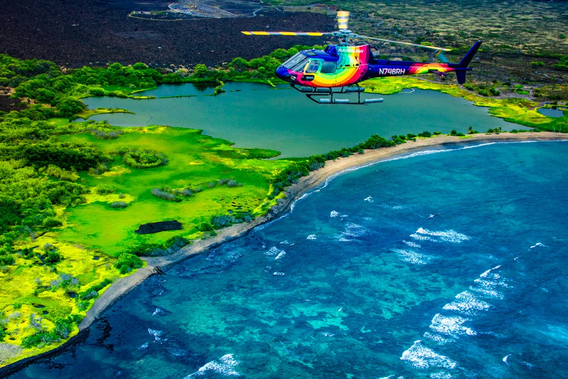 Big Island helicopter tour. Rainbow Helicopters flying over Kona coast fish ponds on Hawaii Island.