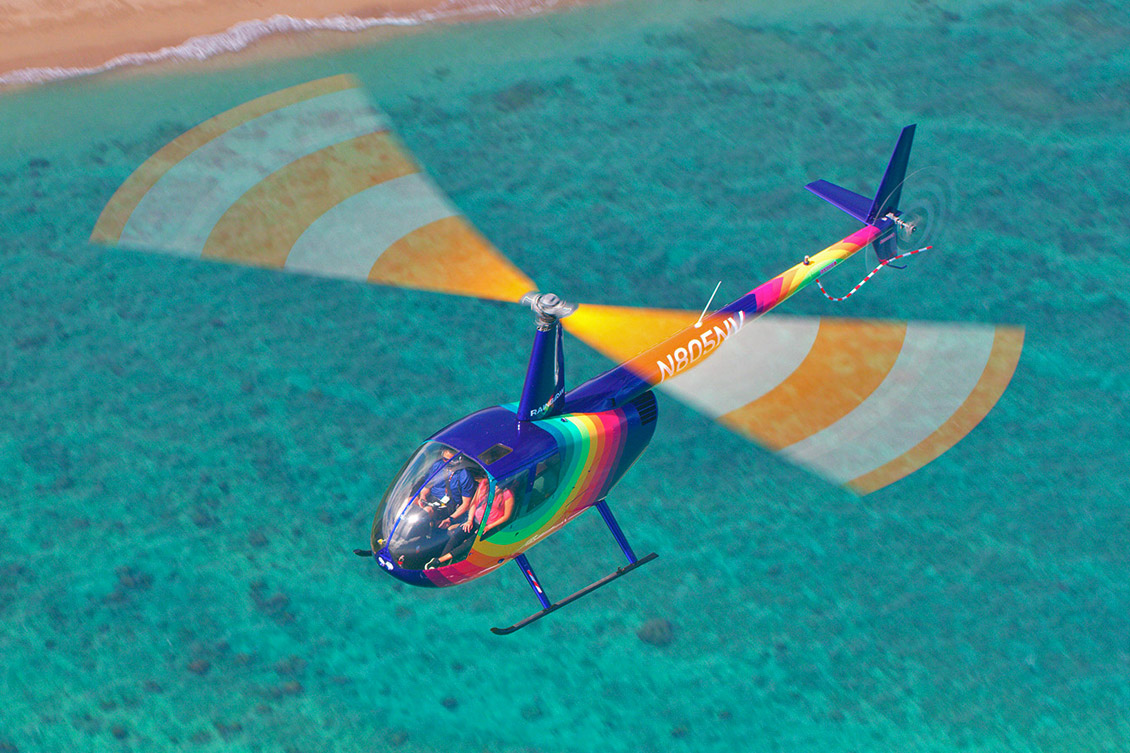Rainbow Helicopters r44 over blue water