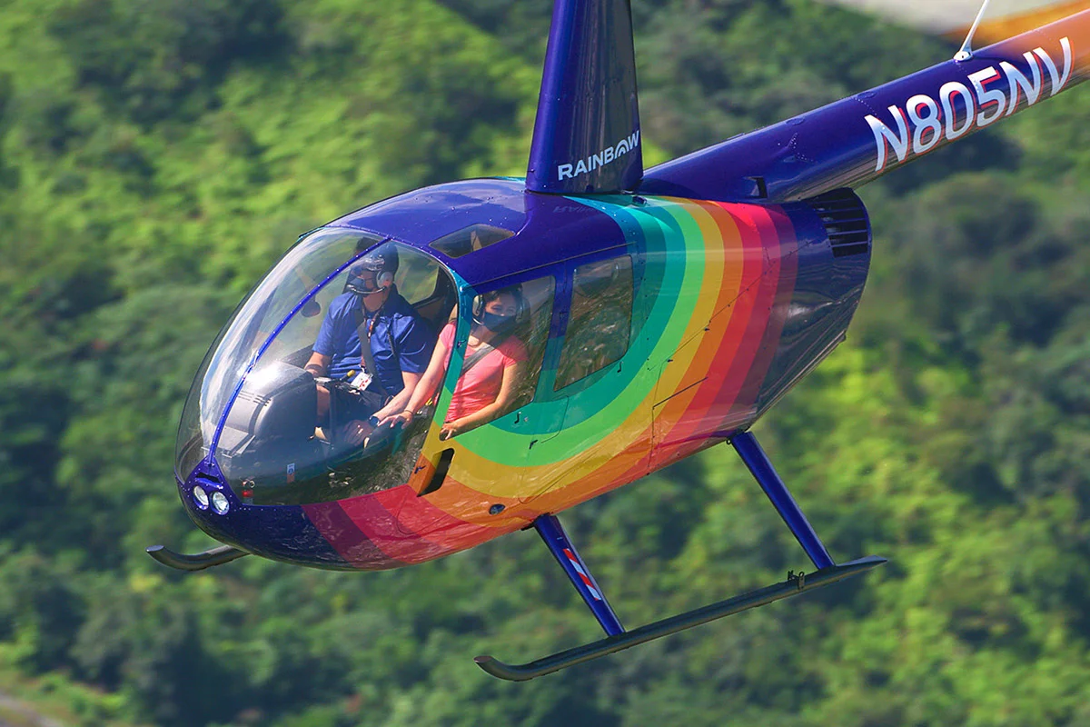 Rainbow Helicopters Robinson R44 flies above Oahu forest on Hawaii Helicopter tours