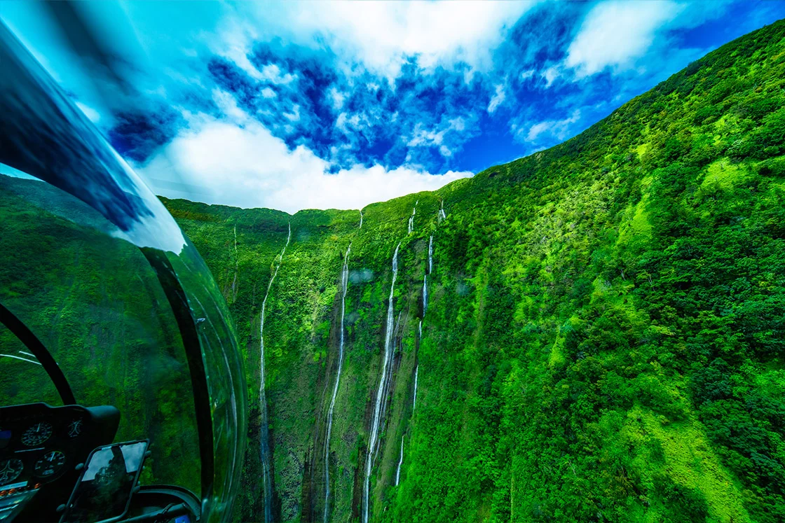 Hawaii Big Island Helicopter Tours over Waimanu Falls with Rainbow Helicopters.